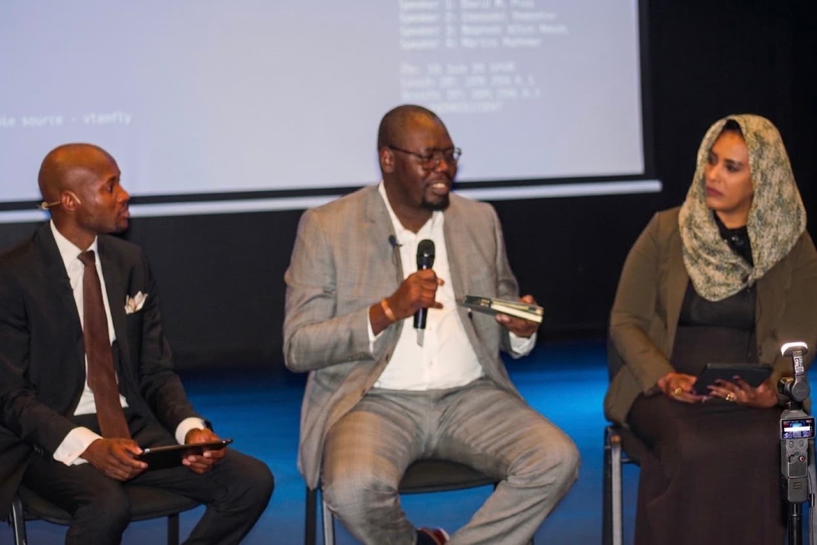 A public dialogue session with participants seated in a circle
